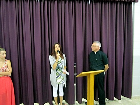 Leah Gordonmakes a presentation to Father Michael on behalf of the Children's Liturgy group