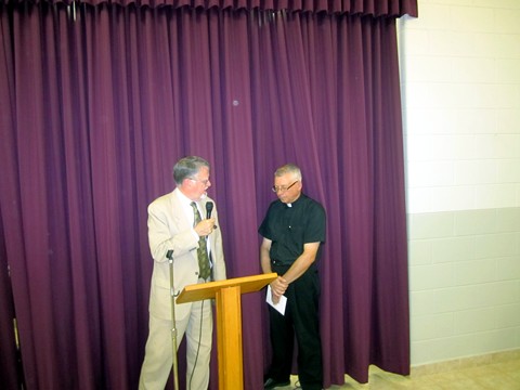 (L-R)  Grand Knight William Mathie from Kof C Council 1394 makes a presentation to Father Michael