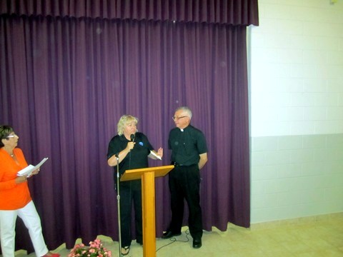 Colleen from the Ozanam Centre presents a gift of thanks to Father Michael for all of his support of  Ozanam Centre